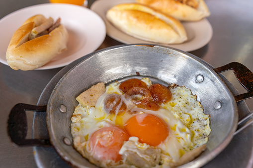 Photo of a breakfast set of Thai pan fried eggs with thai vietnamese bread stuffed with thai pork and chinese sausage, a daily breakfast set from Northeast of Thailand.