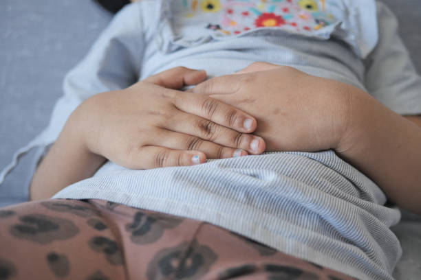 istock child suffering stomach pain close up. 1554927945