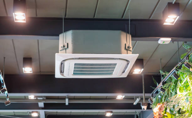 istock Modern ceiling mounted cassette type air conditioning system in coffee shop 1554928157