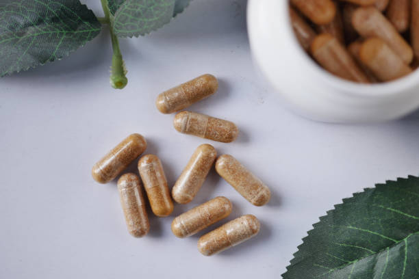 istock top view of herbal medicine capsule dropping on table 1554928645