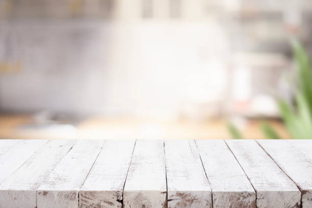 istock Selective focus.Wood table top on blur kitchen counter background.For montage product display or design key visual layout. 1554993975