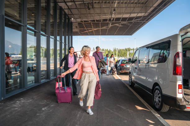 Tourists Looking a Shuttle Transportation Service at The Airport stock photo