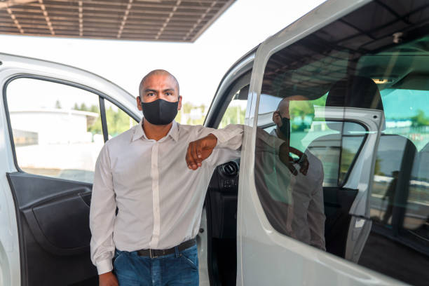 istock Hispanic Airport Shuttle Driver Wearing a Protective Face Mask 1554996076