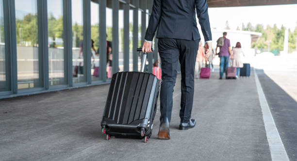 istock Businessman Dragging A Suitcase At The Airport 1554996088