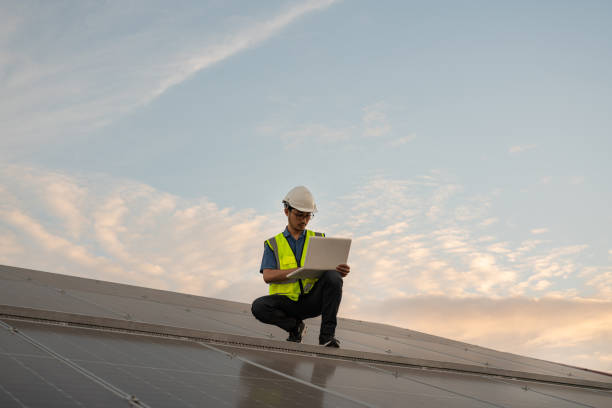 istock Service Engineer use tablet working inspection installation solar cell on the roof. 1555034366