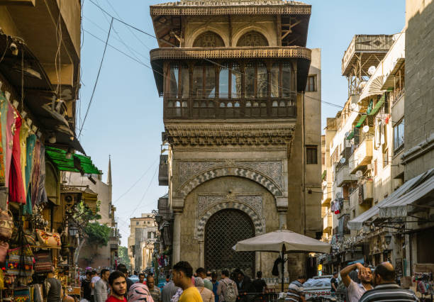 07/14/2023,Cairo,Egypt:Tourists and locals are shopping at Khan al-khalili market in Cairo.Khan al-khalili is the most famous and largest market in Arabia.Traditional mosque and church can be seen in the background.