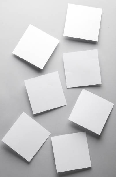 istock White empty square memo sheets of paper on gray background. Template for design. 1555042642