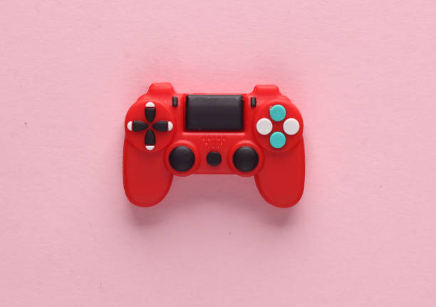 istock Red toy gamepad on a pink background. Top view 1555044199