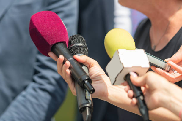 istock Journalists with Microphones at Green Agenda Event 1555046888
