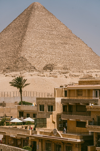Excavations in front of the great Pyramid of Cheops in the Giza valley. Cairo Egypt. Pyramids of Khafra against the blue sky.