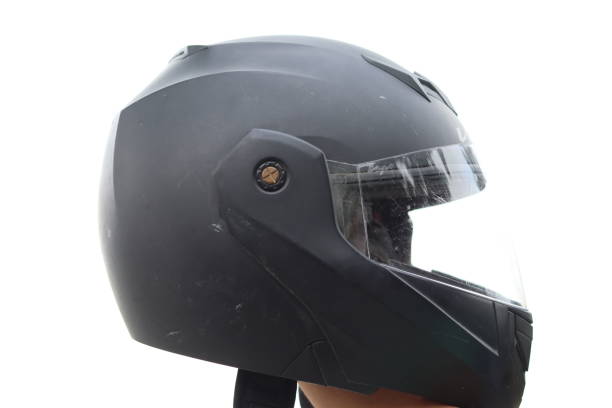 istock A Matte Black Helmet held in hand in a White Isolated background 1555086225