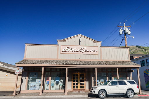 Eddie Bauer Clothes Shop on South Cache Street at Jackson (Jackson Hole) in Teton County, Wyoming, with a car parked outside.