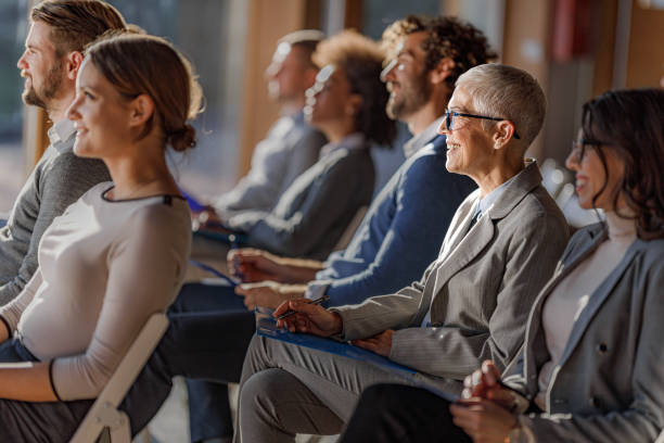 istock Large group of entrepreneurs attending a seminar in board room. 1555095848