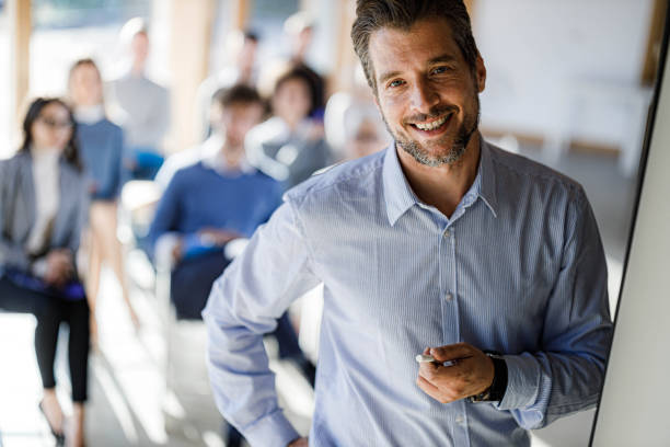 istock Happy presenter during business presentation in the office. 1555105833