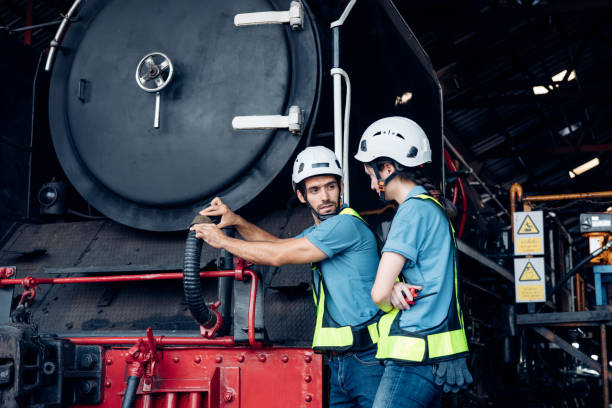 istock Team of engineer railway wearing safety uniform and helmet under checking under train ,wheels and control system for safety travel passenger. Banner cover design. 1555115379