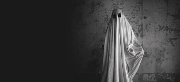 istock Scary ghost on gray background. Halloween concept 1555121297
