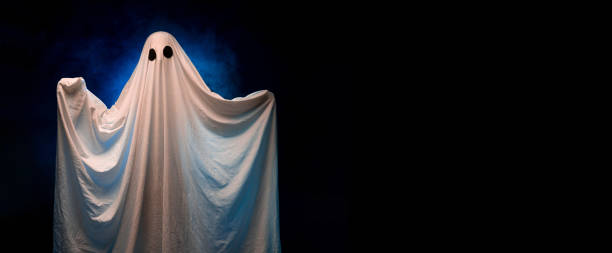 istock Halloween and creepy concept. Ghost on dark smoke background 1555121299