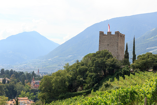 Merano, Italy - September 4, 2021: Panorama view of Powder Tower above Merano and mountains in South Tyrol, Italy