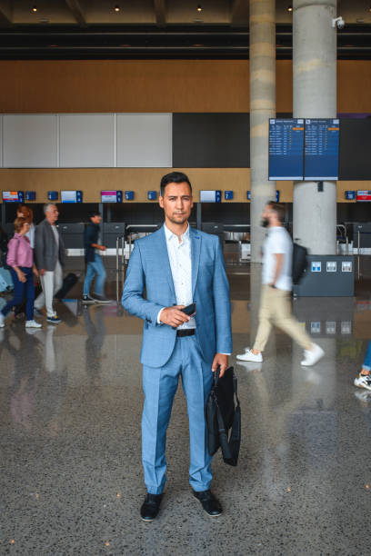 istock Asian Businessman Using A Smartphone At The Airport 1555145570