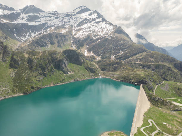 istock Aerial drone view: Concrete dam in the Swiss Alps 1555166309