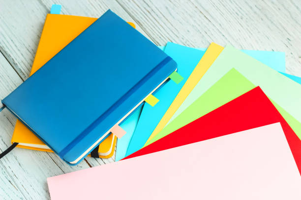 istock Notebook diary for planning in blue and yellow and colored cardboard for creativity 1555171758