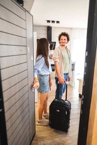 istock Young couple on vacation walking into their hotel room 1555177647