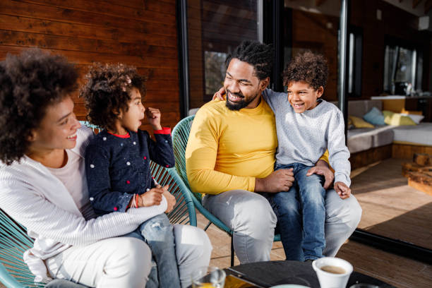 istock Happy black family talking on a terrace. 1555185931