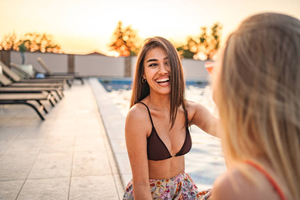 istock Two bestfriends hanging out by the pool 1555186506