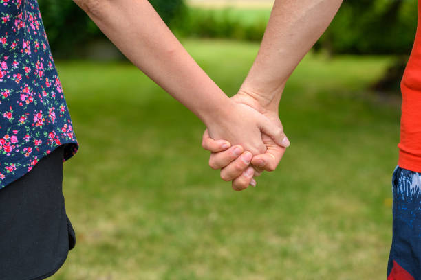 istock Couple on a walk, holding hands, young people 1555202352