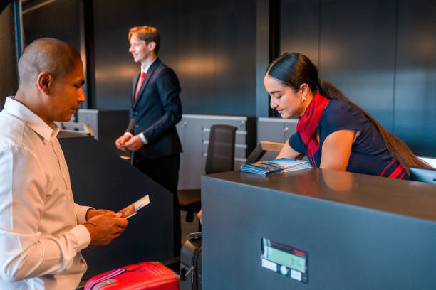 istock Young Adult Asian Airline Stewardess Checking A Boarding Pass 1555213962