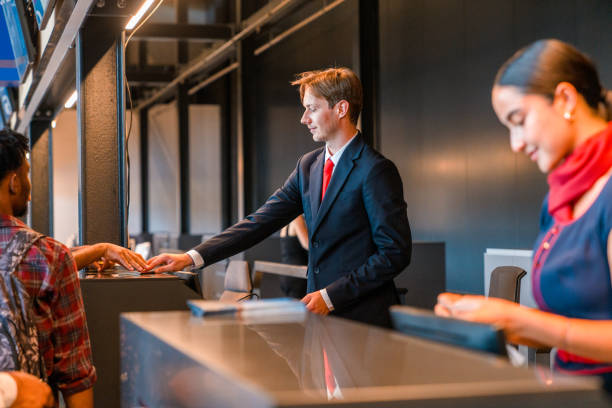 istock Caucasian Airline Steward At A Checking A Boarding Pass 1555213973