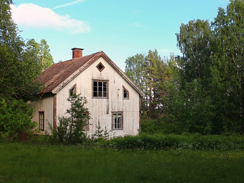 Olsztynek, Poland - August 31,2019: Old rural log house with herbal pump room, Warmian-Masurian Voivodeship, Poland