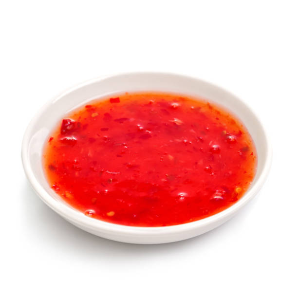 istock Sweet chilli sauce in a white ceramic bowl on white. 1555264819