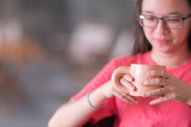 istock Young lady indoor glamping with coffee cup 1555265443