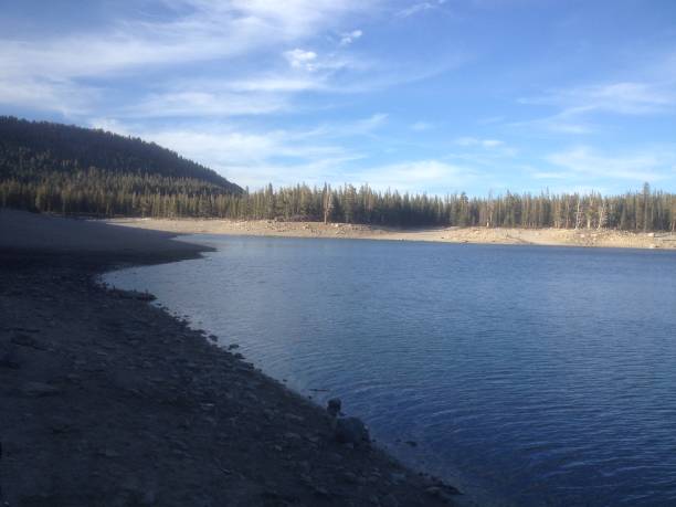 istock Beach side view of a shadowed lake 1555279293