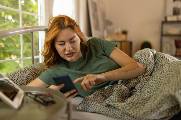 istock Young woman checking the time after waking up 1555298457