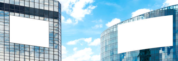 istock Two outdoor billboard on building  with blue sky background 1555299066