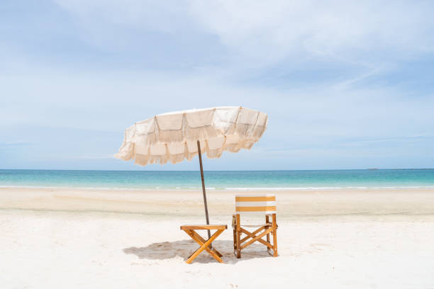 istock Beach umbrellas and chairs with white sand and perfect blue sky. 1555304544