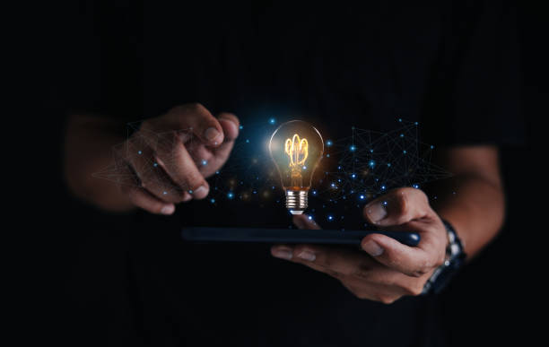 istock Creative solution or idea for web banner design or landing page template for creative agency with hands coming out of the screen with light bulbs and colorful abstract geometric shapes and lead lines. 1555340780