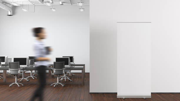 istock Blank roll up banner stand mock up in modern office. 1555349341