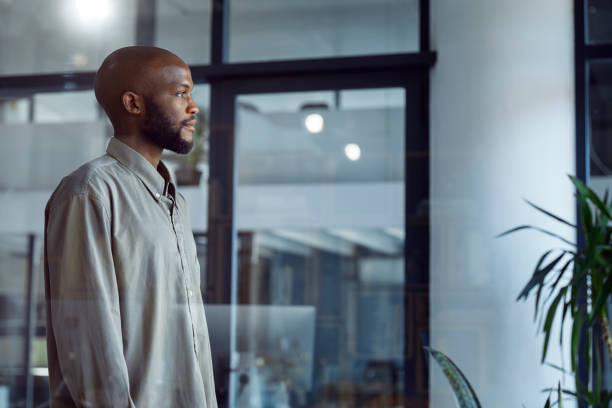 istock Glimpses of Opportunity: A Businessman's Window Reflection 1555354251