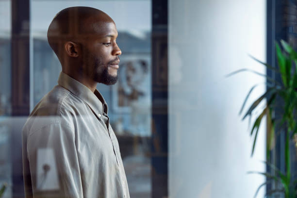 istock Glimpses of Opportunity: A Businessman's Window Reflection 1555354254