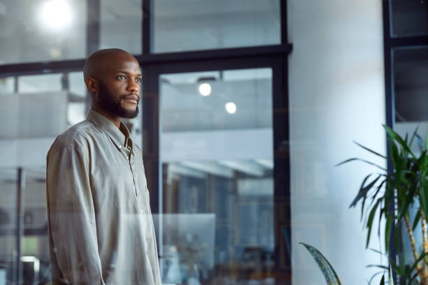 istock Glimpses of Opportunity: A Businessman's Window Reflection 1555354259