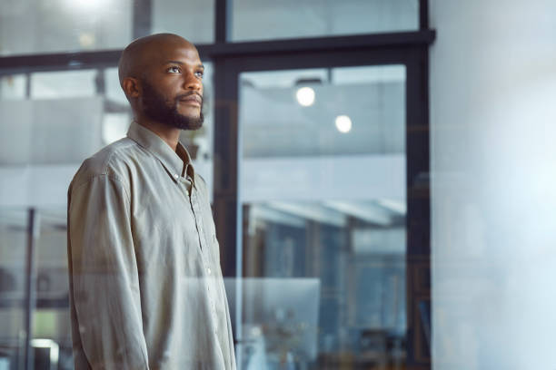istock Glimpses of Opportunity: A Businessman's Window Reflection 1555354576