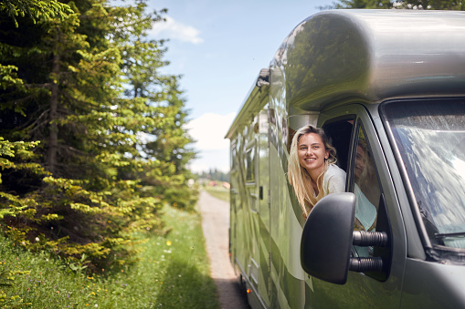 freedom journey travel with off road.Smiling girl on  vacation travel RV, holiday trip