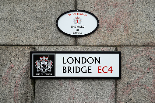 London, UK - January 29, 2023: The Ward of Bridge and London Bridge street signs on a wall in the City of London, UK.