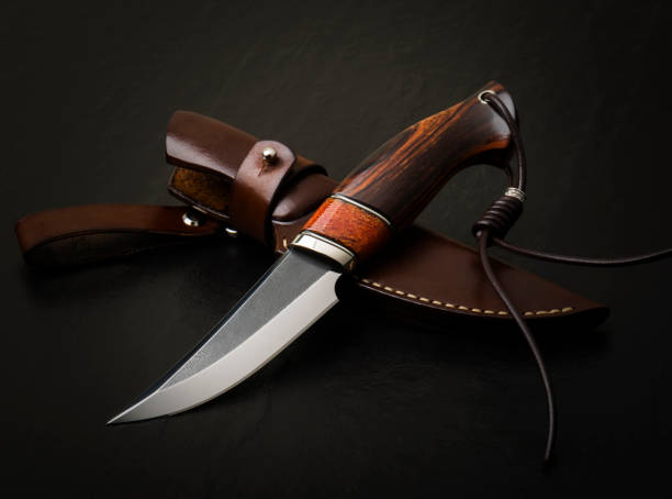 istock Hunting knife handmade on a black background. Leather Sheath Handmade 1555390988