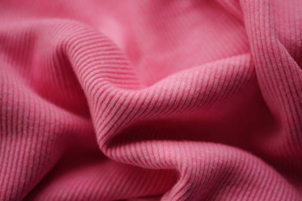 istock jersey pink fine ribbed pattern, soft wrinkled fabric. 1555410985