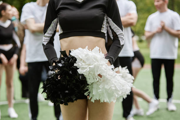 istock Cheerleader girl dancing with pompom 1555414696