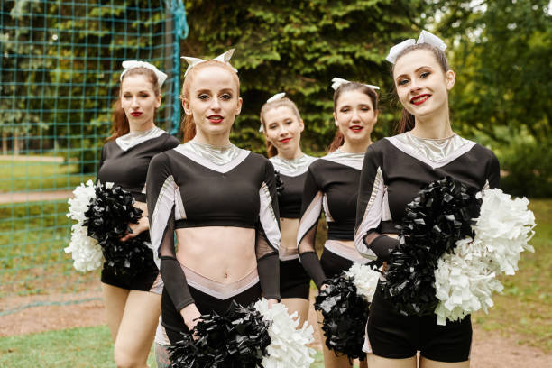 istock Cheerleading girls training outdoors 1555421611